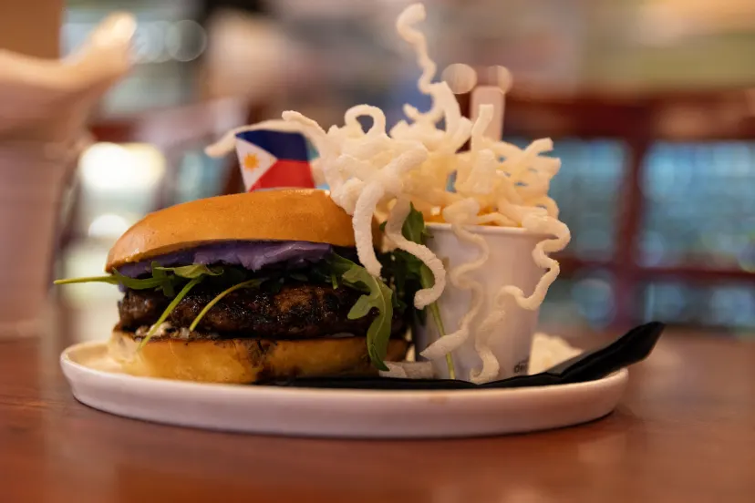 Lazy Juan's Marites burger with garlic fried rice noodles and buttered corn